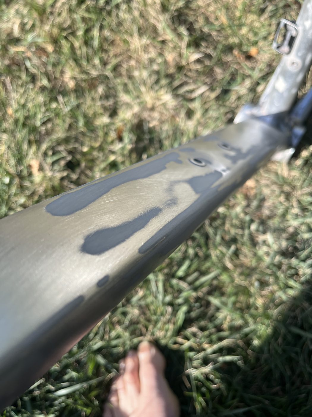 The original paint being stripped from an aluminium Trek Emonda frame.