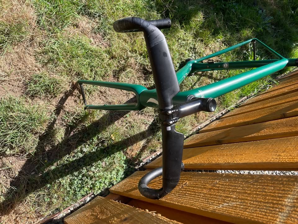 Green Specialized Aethos frameset leaning against a fence with its fork, seatpost and saddle fitted, from the seller's Marketplace listing. Photo 4 of 4.