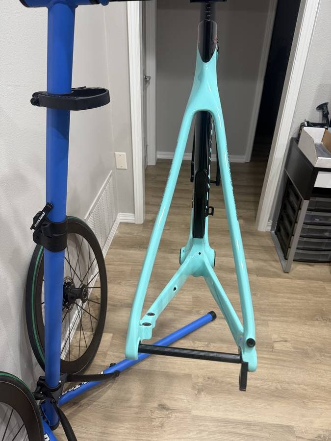 Celeste and black Bianchi Oltre XR4 frame and fork with the black Vision cockpit fitted, on a blue work stand with wheels in, from the seller's Craigslist listing. Photo 2 of 15.