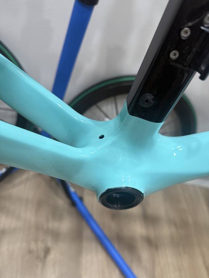 Celeste and black Bianchi Oltre XR4 frame and fork with the black Vision cockpit fitted, on a blue work stand with wheels in, from the seller's Craigslist listing. Photo 3 of 15.