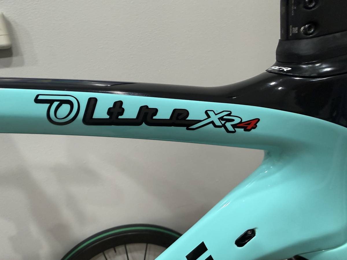 Celeste and black Bianchi Oltre XR4 frame and fork with the black Vision cockpit fitted, on a blue work stand with wheels in, from the seller's Craigslist listing. Photo 4 of 15.