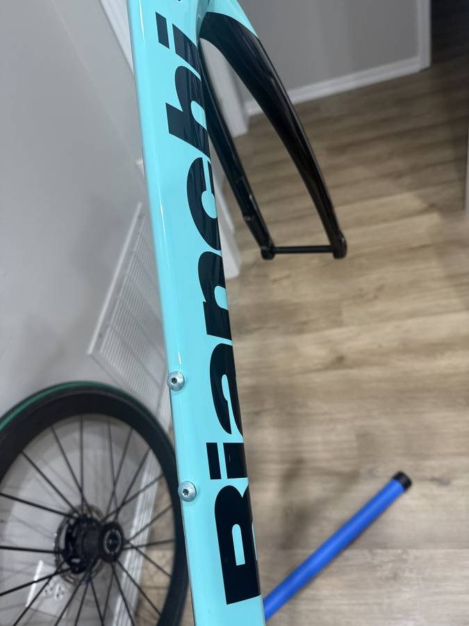 Celeste and black Bianchi Oltre XR4 frame and fork with the black Vision cockpit fitted, on a blue work stand with wheels in, from the seller's Craigslist listing. Photo 5 of 15.