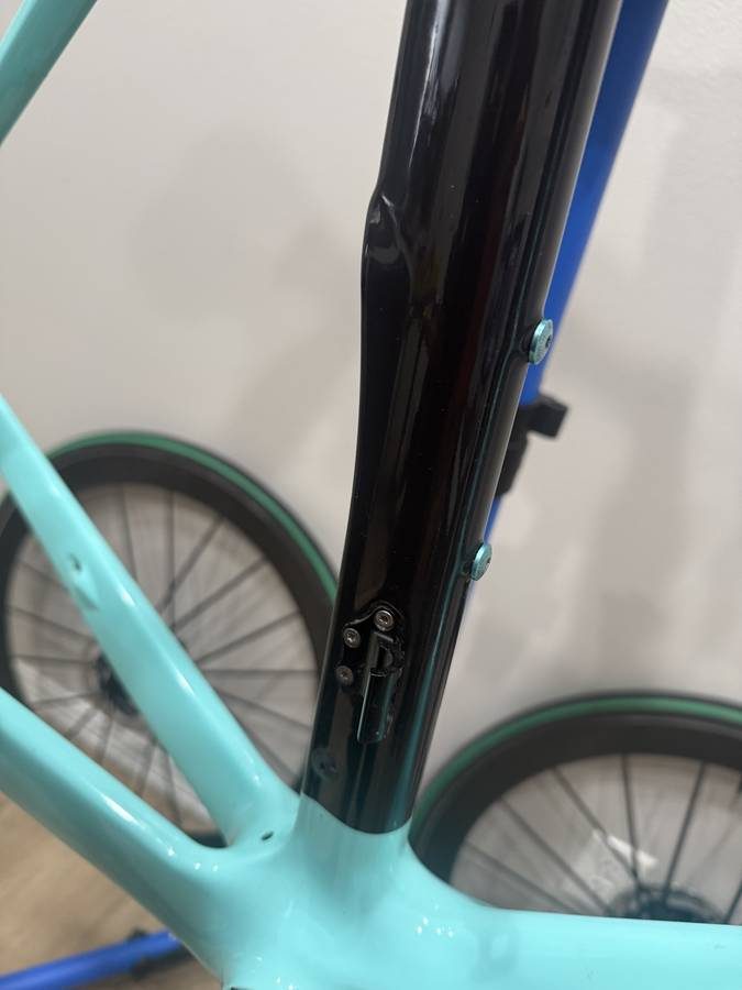 Celeste and black Bianchi Oltre XR4 frame and fork with the black Vision cockpit fitted, on a blue work stand with wheels in, from the seller's Craigslist listing. Photo 6 of 15.