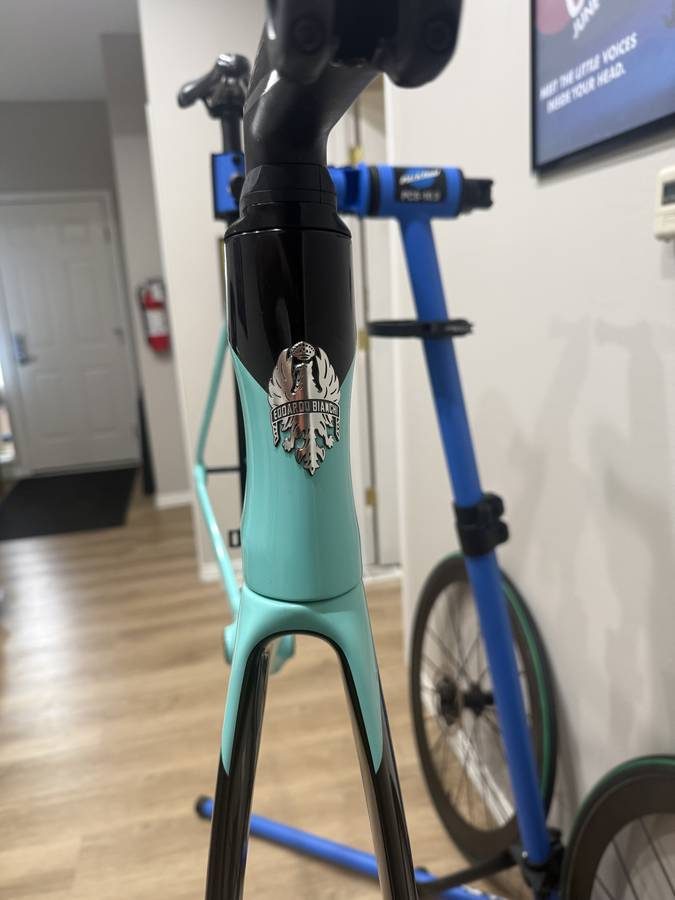 Celeste and black Bianchi Oltre XR4 frame and fork with the black Vision cockpit fitted, on a blue work stand with wheels in, from the seller's Craigslist listing. Photo 7 of 15.