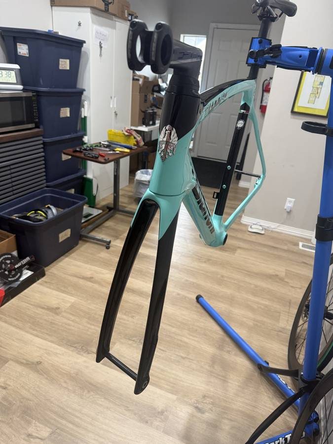 Celeste and black Bianchi Oltre XR4 frame and fork with the black Vision cockpit fitted, on a blue work stand with wheels in, from the seller's Craigslist listing. Photo 8 of 15.
