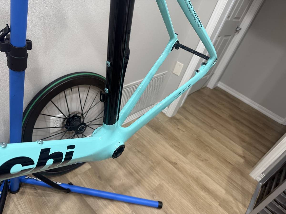 Celeste and black Bianchi Oltre XR4 frame and fork with the black Vision cockpit fitted, on a blue work stand with wheels in, from the seller's Craigslist listing. Photo 10 of 15.