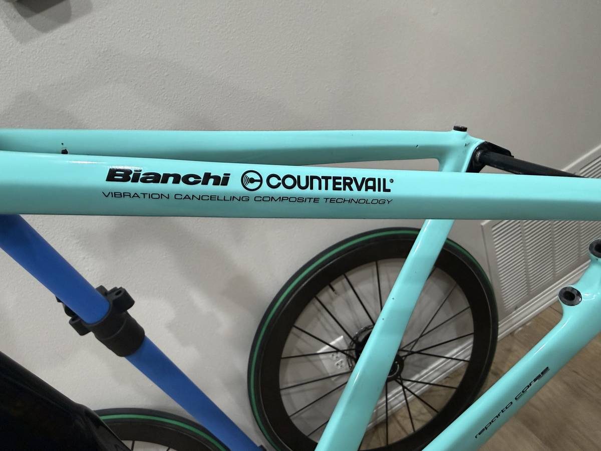 Celeste and black Bianchi Oltre XR4 frame and fork with the black Vision cockpit fitted, on a blue work stand with wheels in, from the seller's Craigslist listing. Photo 11 of 15.