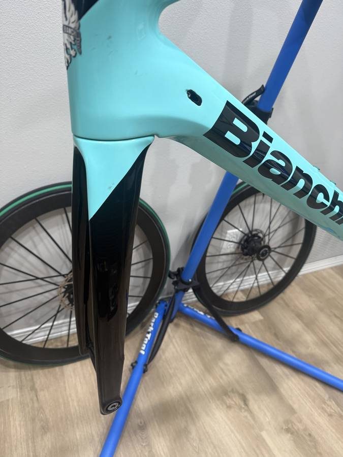 Celeste and black Bianchi Oltre XR4 frame and fork with the black Vision cockpit fitted, on a blue work stand with wheels in, from the seller's Craigslist listing. Photo 12 of 15.