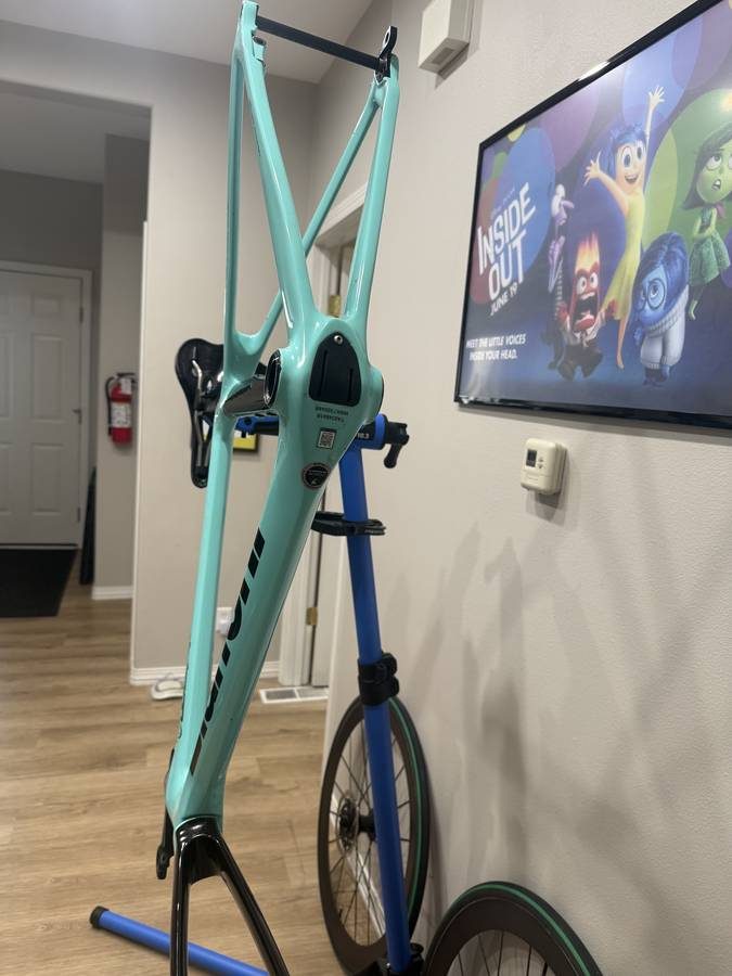 Celeste and black Bianchi Oltre XR4 frame and fork with the black Vision cockpit fitted, on a blue work stand with wheels in, from the seller's Craigslist listing. Photo 14 of 15.