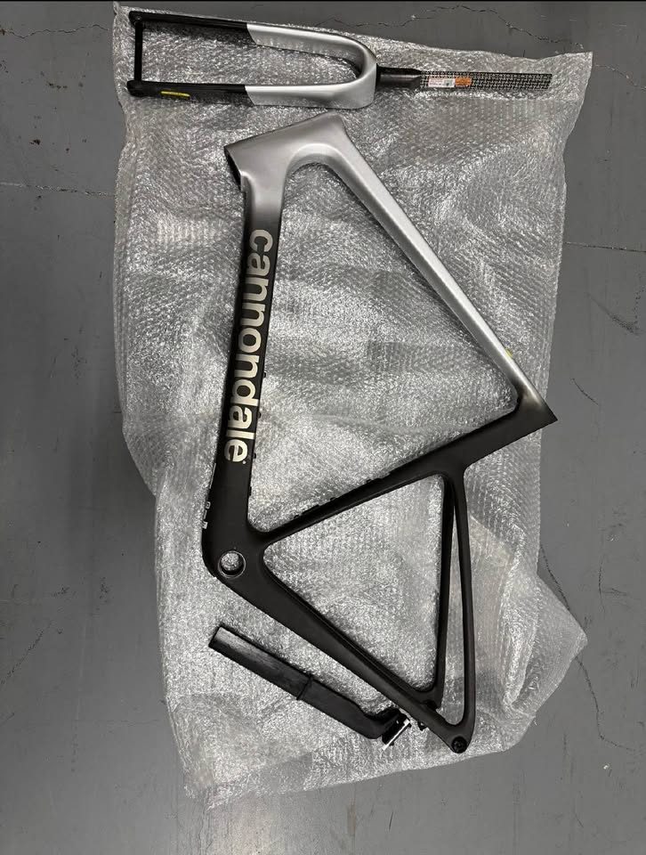 Matte black Cannondale SuperSix EVO Hi-MOD frame and fork with a silver fade on the top tube, laid on bubble wrap, from the seller's Marketplace listing.