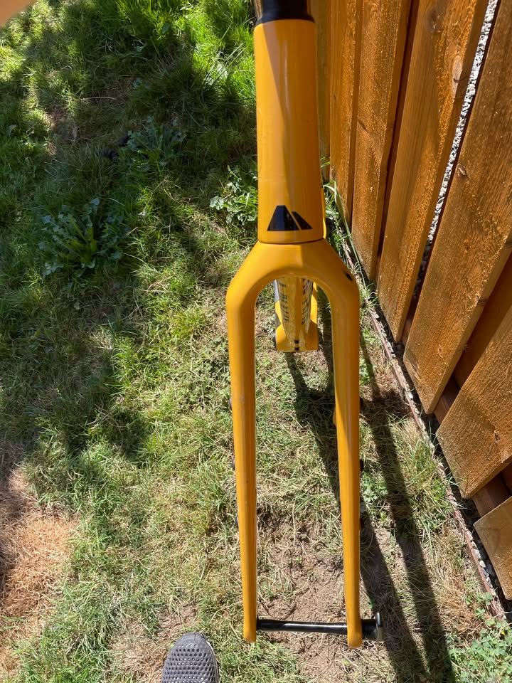 Mustard yellow Canyon Grizl carbon frameset leaning against a wooden fence with its fork, stem and seatpost alongside, from the seller's Marketplace listing. Photo 2 of 5.