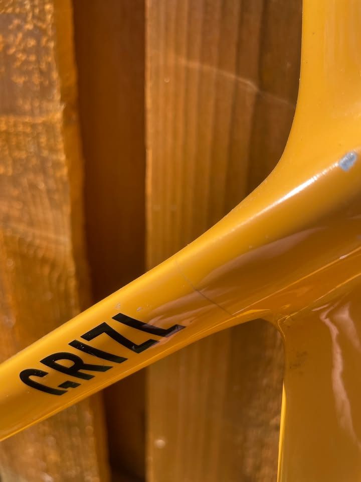 Mustard yellow Canyon Grizl carbon frameset leaning against a wooden fence with its fork, stem and seatpost alongside, from the seller's Marketplace listing. Photo 3 of 5.
