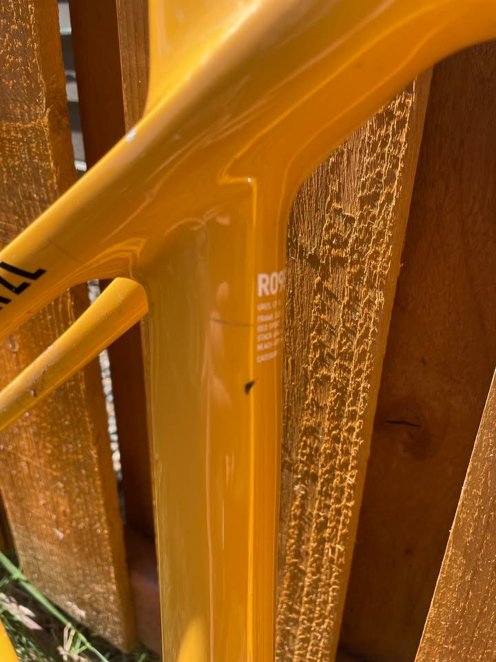 Mustard yellow Canyon Grizl carbon frameset leaning against a wooden fence with its fork, stem and seatpost alongside, from the seller's Marketplace listing. Photo 4 of 5.