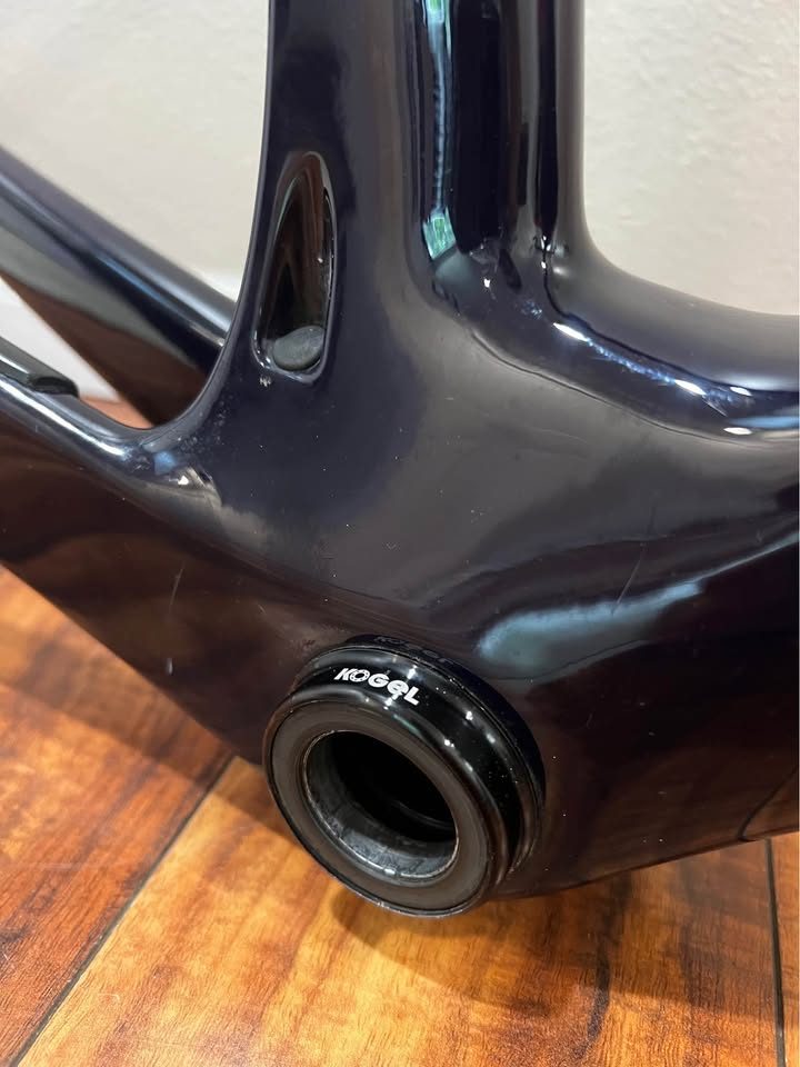 Black Cervélo Caledonia-5 frameset with the bar and stem fitted, leaning against a wall on a wood floor, from the seller's Marketplace listing. Photo 2 of 7.