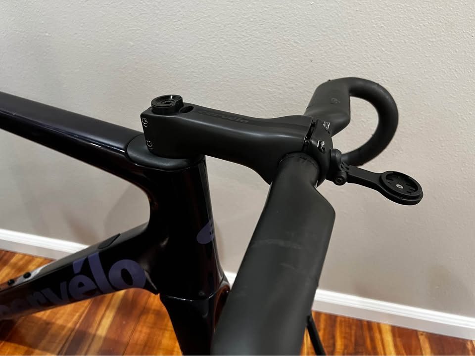Black Cervélo Caledonia-5 frameset with the bar and stem fitted, leaning against a wall on a wood floor, from the seller's Marketplace listing. Photo 3 of 7.