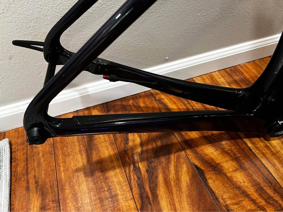 Black Cervélo Caledonia-5 frameset with the bar and stem fitted, leaning against a wall on a wood floor, from the seller's Marketplace listing. Photo 4 of 7.