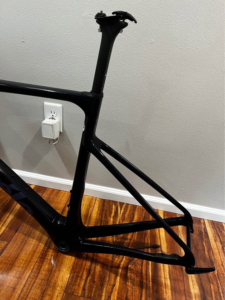 Black Cervélo Caledonia-5 frameset with the bar and stem fitted, leaning against a wall on a wood floor, from the seller's Marketplace listing. Photo 5 of 7.