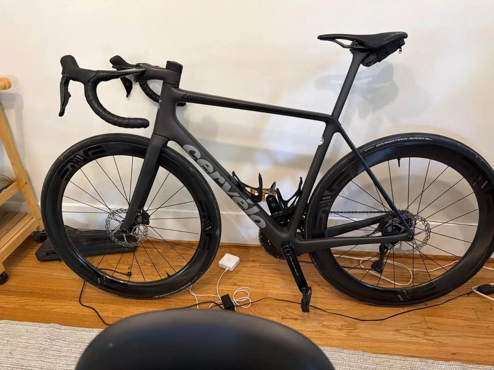 Black Cervélo R5 built up with drop bars and deep carbon wheels, leaning against a wall indoors, from the seller's Marketplace listing. Photo 2 of 4.
