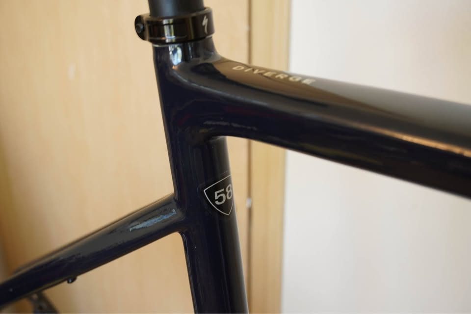 Dark navy Specialized Diverge carbon frame and fork hanging on a workshop stand with the stem fitted and no wheels or drivetrain, from the seller's Marketplace listing. Photo 2 of 5.