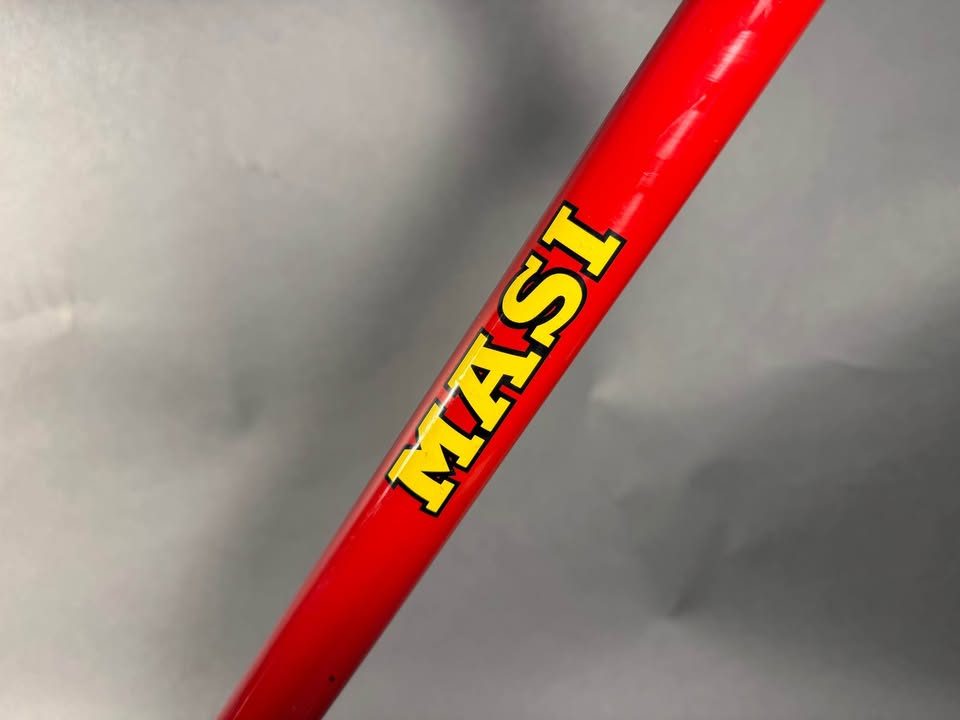 Red lugged steel Masi track frame and matching fork on a grey studio backdrop, MASI in yellow on the down tube and Italian tricolour bands on the seat tube, from the seller's Marketplace listing. Photo 2 of 10.