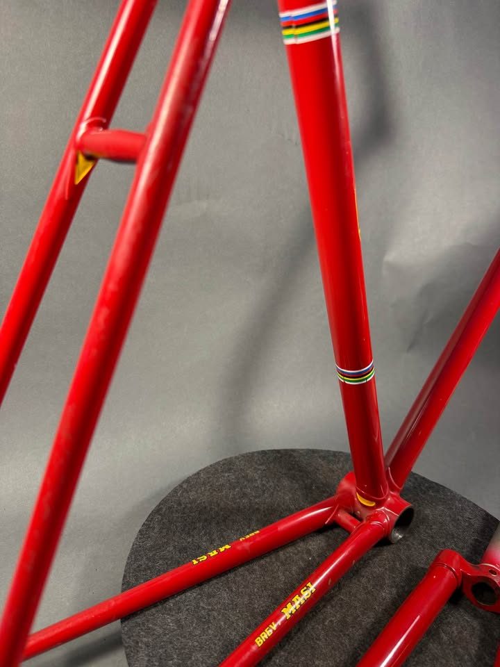 Red lugged steel Masi track frame and matching fork on a grey studio backdrop, MASI in yellow on the down tube and Italian tricolour bands on the seat tube, from the seller's Marketplace listing. Photo 7 of 10.