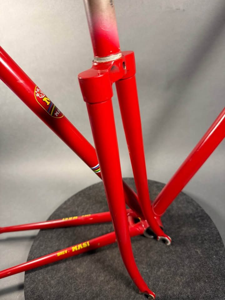 Red lugged steel Masi track frame and matching fork on a grey studio backdrop, MASI in yellow on the down tube and Italian tricolour bands on the seat tube, from the seller's Marketplace listing. Photo 9 of 10.
