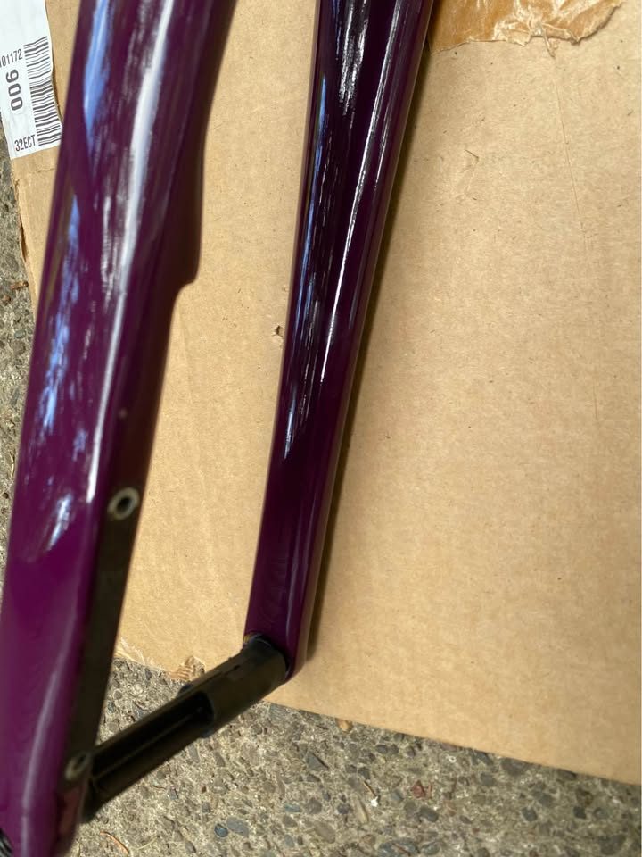 Brushed titanium Mosaic road frameset laid out on cardboard next to its purple carbon fork, from the seller's Marketplace listing. Photo 5 of 8.