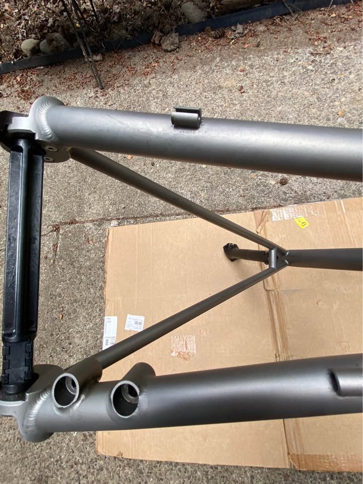 Brushed titanium Mosaic road frameset laid out on cardboard next to its purple carbon fork, from the seller's Marketplace listing. Photo 6 of 8.