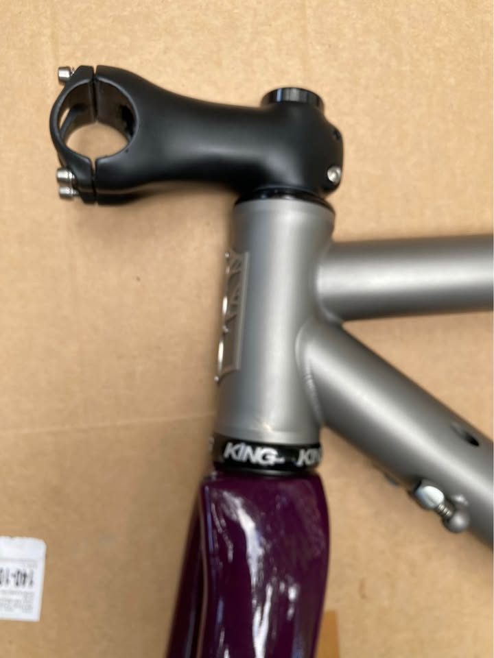 Brushed titanium Mosaic road frameset laid out on cardboard next to its purple carbon fork, from the seller's Marketplace listing. Photo 8 of 8.