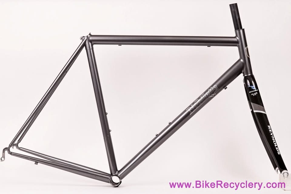 Mark Nobilette steel frame in metallic dark grey with a black carbon fork, on a white background, from Bike Recyclery's Marketplace listing.