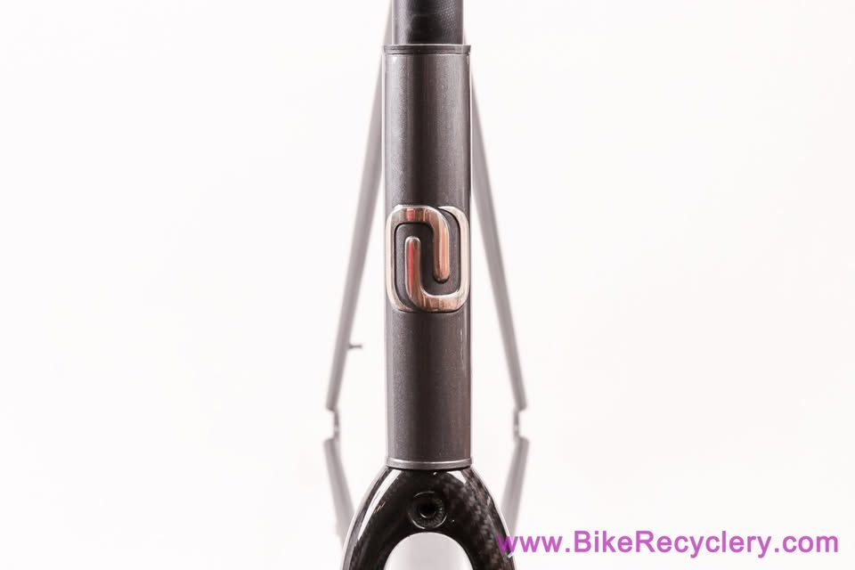 Mark Nobilette steel frame in metallic dark grey with a black carbon fork, on a white background, from Bike Recyclery's Marketplace listing. Photo 2 of 10.