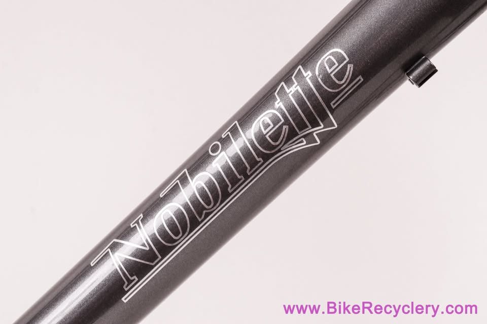 Mark Nobilette steel frame in metallic dark grey with a black carbon fork, on a white background, from Bike Recyclery's Marketplace listing. Photo 3 of 10.