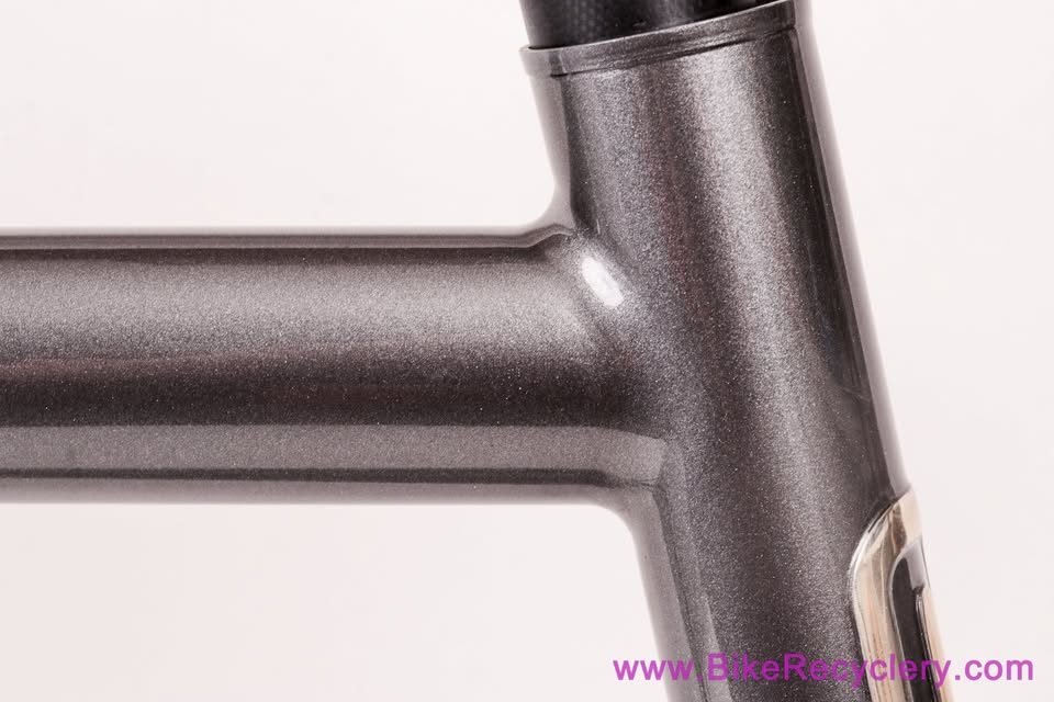 Mark Nobilette steel frame in metallic dark grey with a black carbon fork, on a white background, from Bike Recyclery's Marketplace listing. Photo 7 of 10.