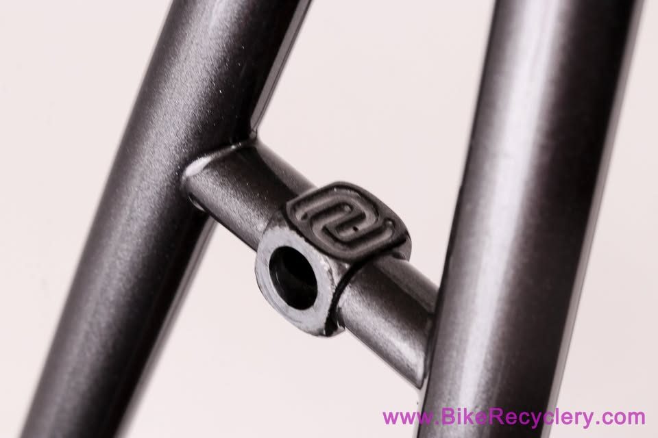Mark Nobilette steel frame in metallic dark grey with a black carbon fork, on a white background, from Bike Recyclery's Marketplace listing. Photo 8 of 10.