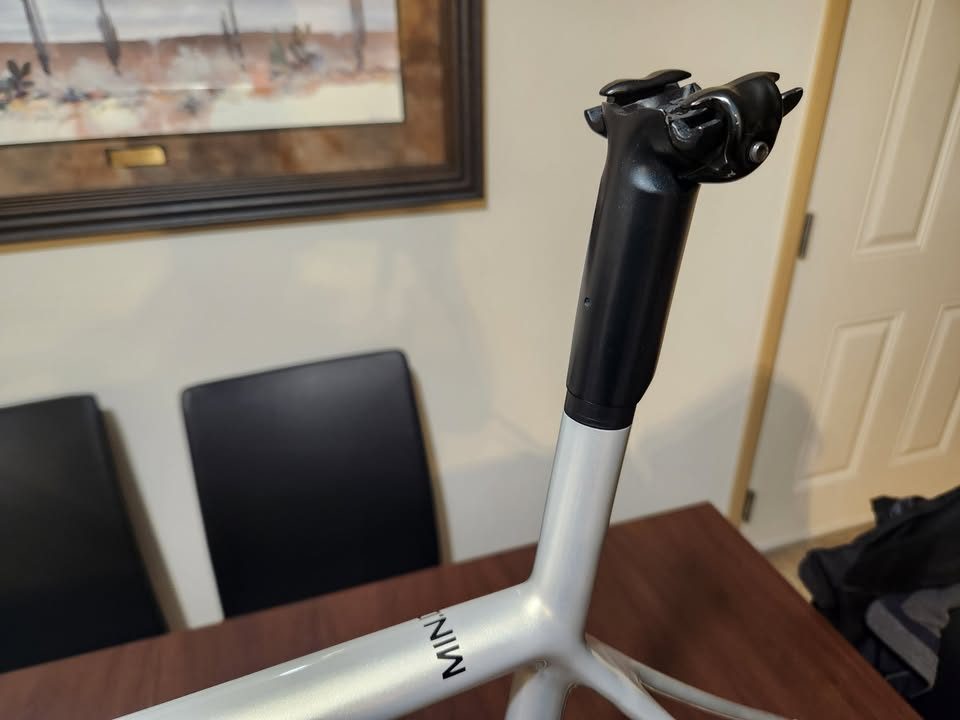 Silver OPEN MIN.D carbon frameset standing on a dining table with its fork, an ENVE stem and a seatpost topper fitted, from the seller's Marketplace listing. Photo 3 of 9.