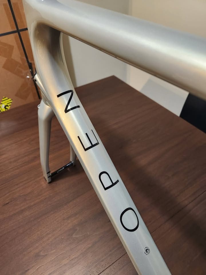 Silver OPEN MIN.D carbon frameset standing on a dining table with its fork, an ENVE stem and a seatpost topper fitted, from the seller's Marketplace listing. Photo 8 of 9.