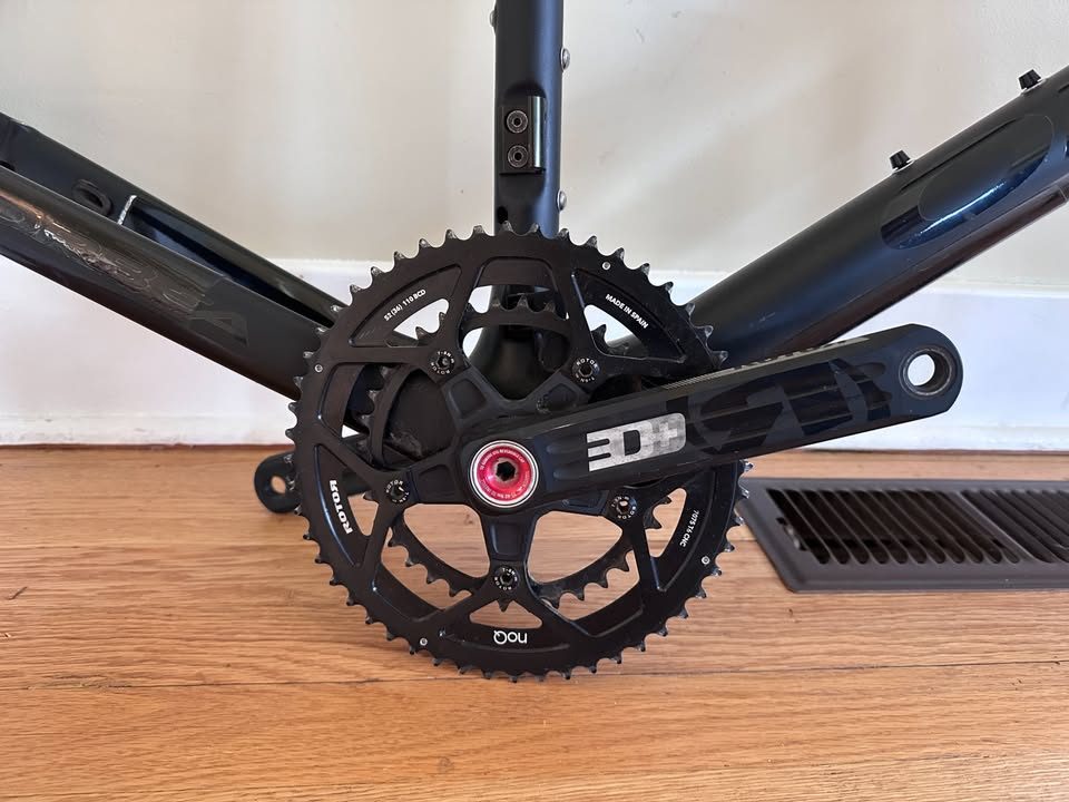 Black Orbea Terra carbon frame and fork with a Rotor crankset fitted and a handlebar and stem on the fork, standing on a wood floor, from the seller's Marketplace listing. Photo 2 of 10.