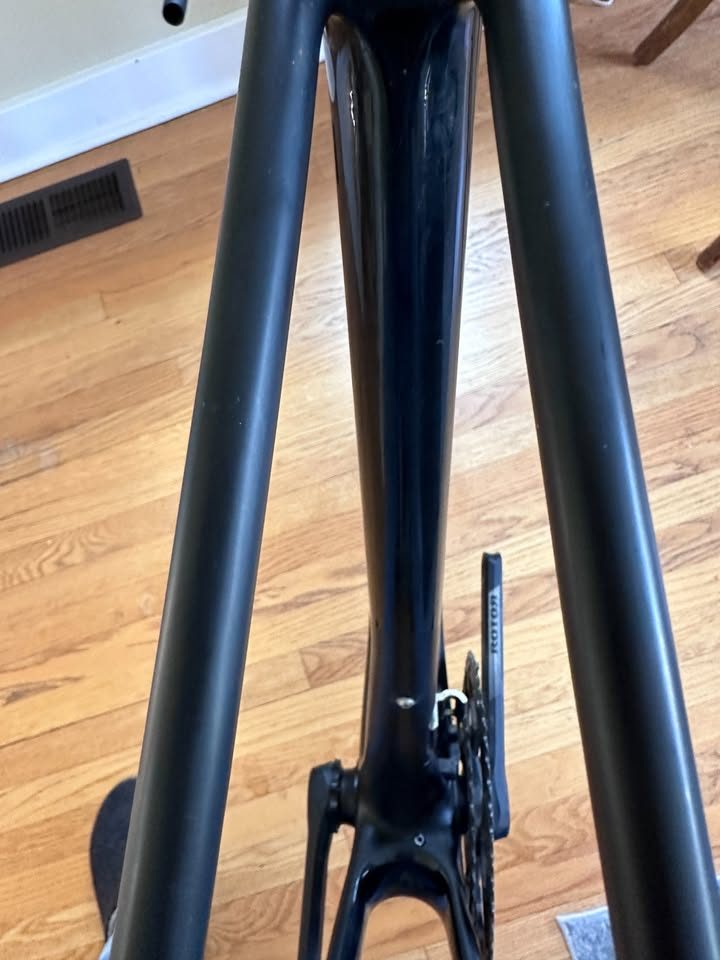 Black Orbea Terra carbon frame and fork with a Rotor crankset fitted and a handlebar and stem on the fork, standing on a wood floor, from the seller's Marketplace listing. Photo 4 of 10.