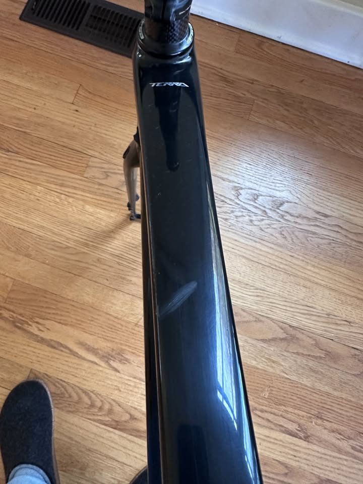 Black Orbea Terra carbon frame and fork with a Rotor crankset fitted and a handlebar and stem on the fork, standing on a wood floor, from the seller's Marketplace listing. Photo 5 of 10.
