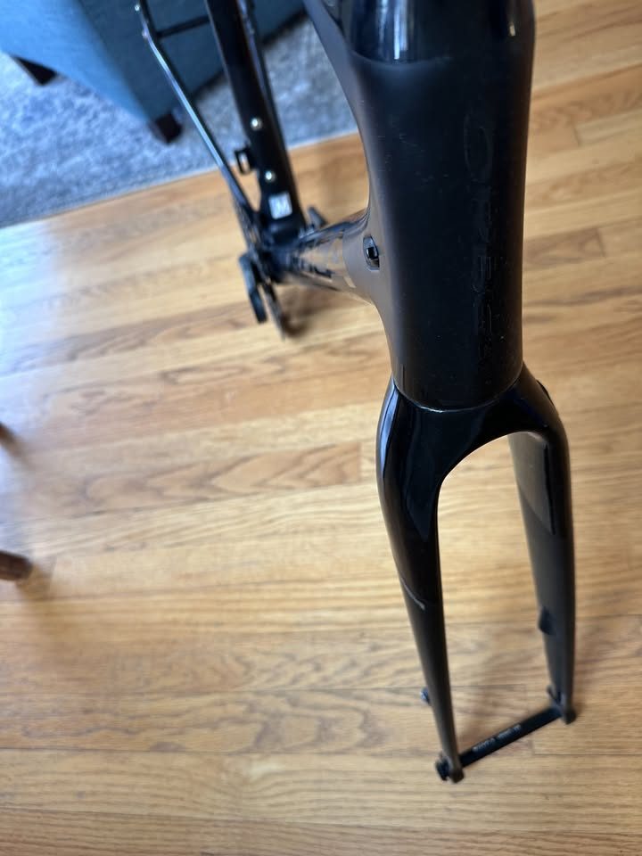Black Orbea Terra carbon frame and fork with a Rotor crankset fitted and a handlebar and stem on the fork, standing on a wood floor, from the seller's Marketplace listing. Photo 6 of 10.