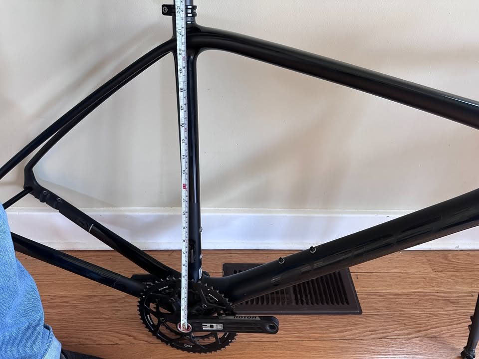 Black Orbea Terra carbon frame and fork with a Rotor crankset fitted and a handlebar and stem on the fork, standing on a wood floor, from the seller's Marketplace listing. Photo 8 of 10.