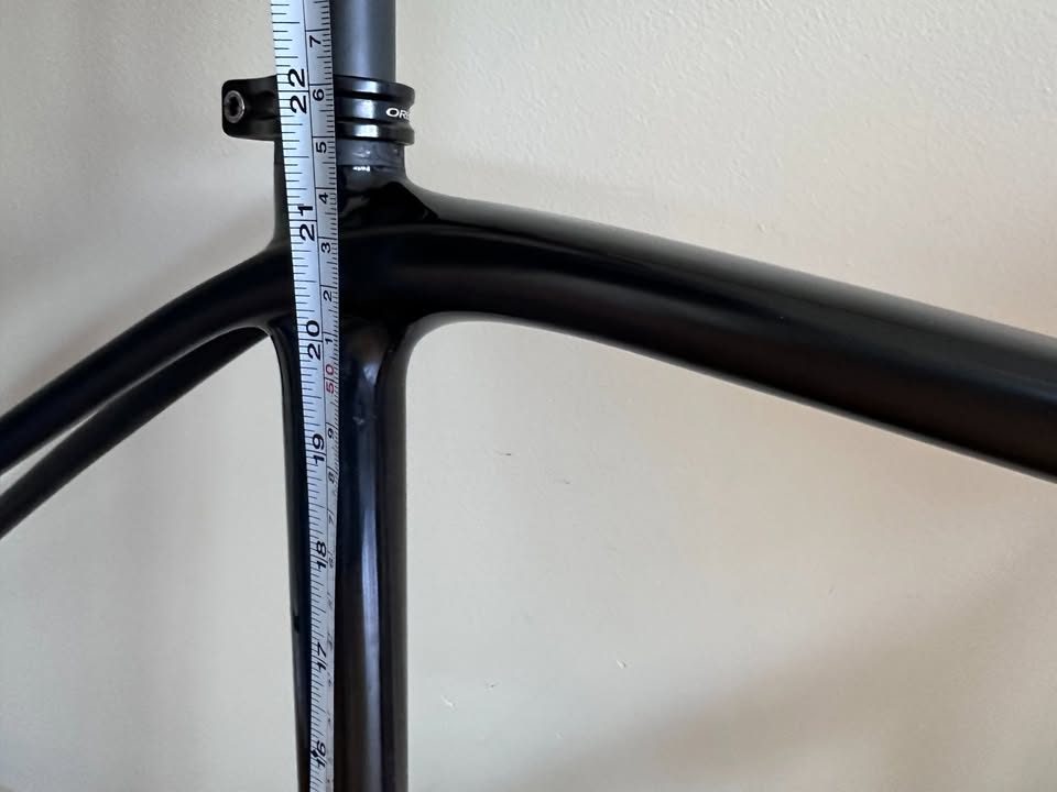 Black Orbea Terra carbon frame and fork with a Rotor crankset fitted and a handlebar and stem on the fork, standing on a wood floor, from the seller's Marketplace listing. Photo 9 of 10.