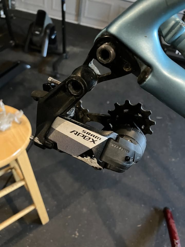 Blue-green Scott carbon frame and fork in a work stand in a garage, with a seatpost, stem and SRAM rear derailleur fitted, from the seller's Marketplace listing. Photo 6 of 6.