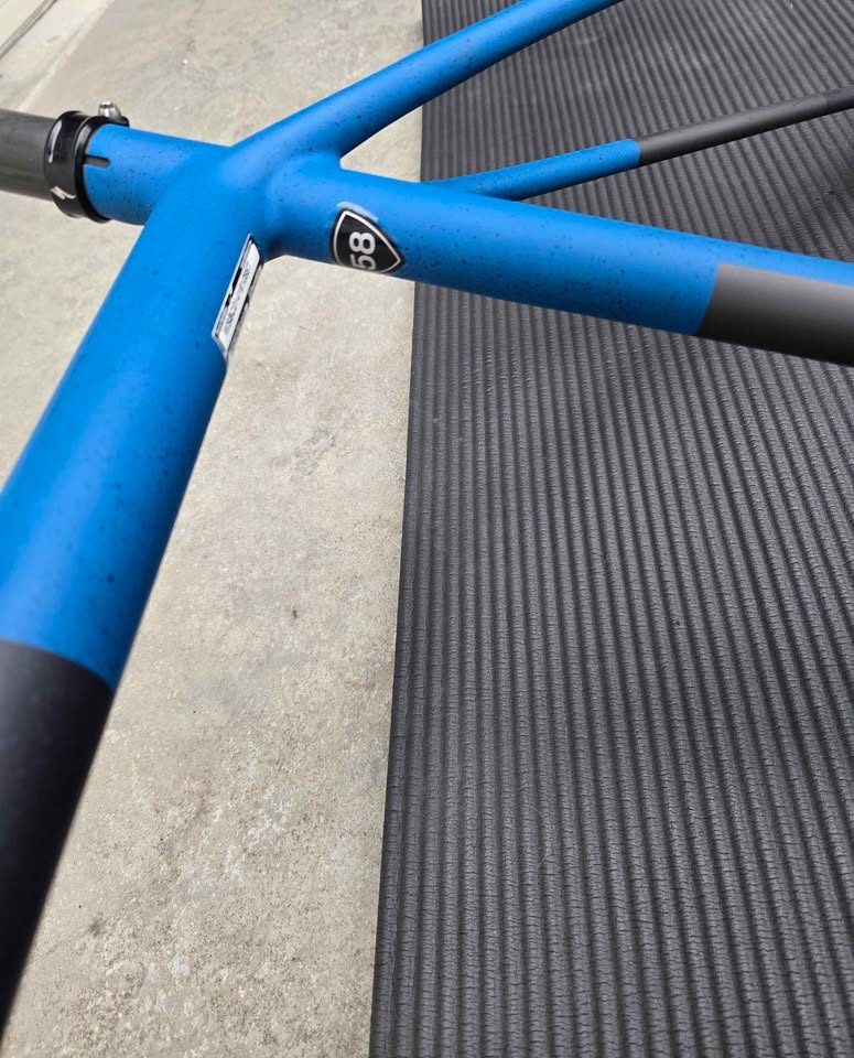 Rear triangle of a matte black S-Works Crux frame with blue speckles, a silver flat mount disc caliper bolted to the chainstay, from the seller's Marketplace listing. Photo 2 of 6.