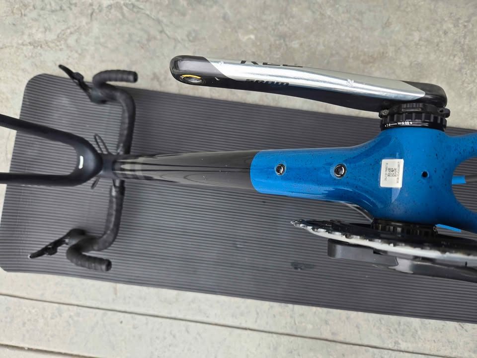 Rear triangle of a matte black S-Works Crux frame with blue speckles, a silver flat mount disc caliper bolted to the chainstay, from the seller's Marketplace listing. Photo 4 of 6.
