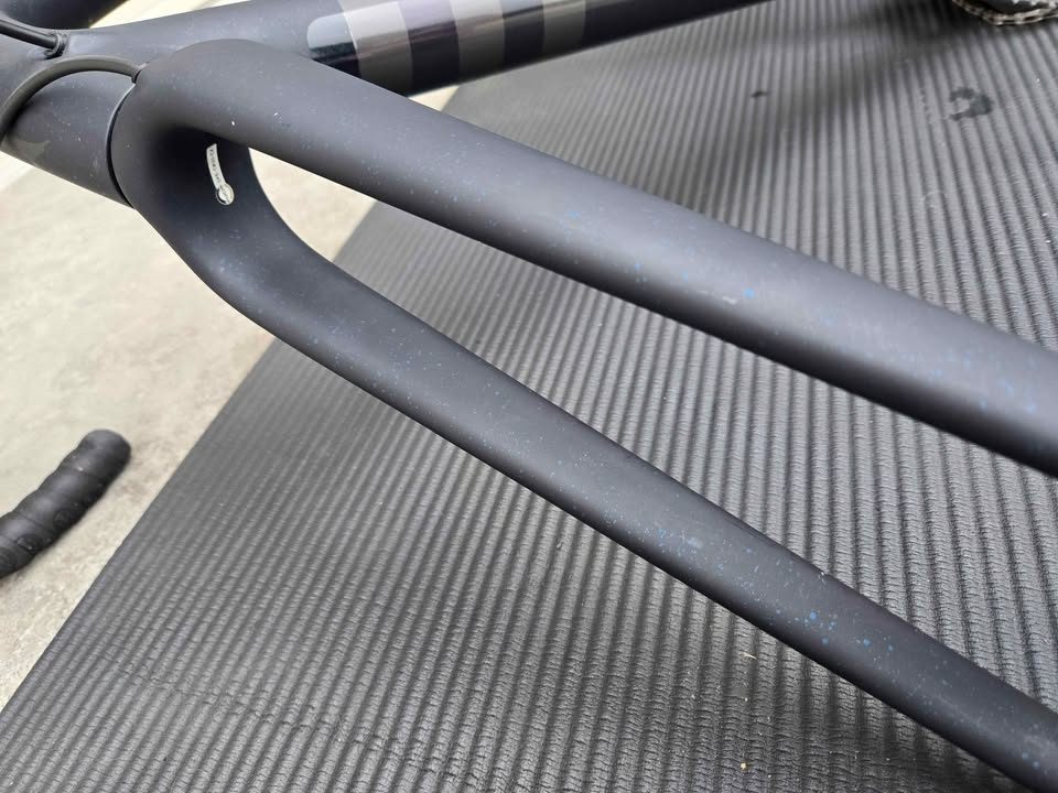 Rear triangle of a matte black S-Works Crux frame with blue speckles, a silver flat mount disc caliper bolted to the chainstay, from the seller's Marketplace listing. Photo 6 of 6.