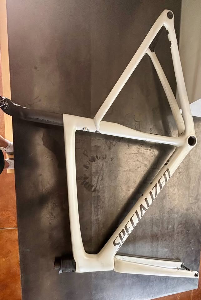 Off-white Specialized Tarmac SL7 frame laid on a dark table with its fork and carbon seatpost alongside, from the seller's Marketplace listing. Photo 2 of 7.