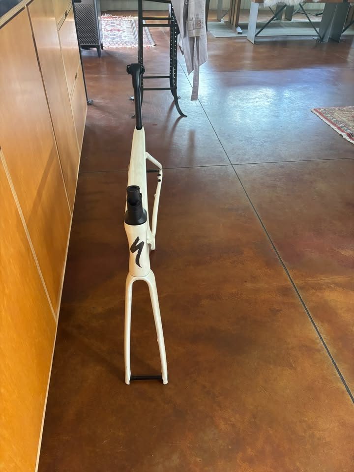 Off-white Specialized Tarmac SL7 frame laid on a dark table with its fork and carbon seatpost alongside, from the seller's Marketplace listing. Photo 6 of 7.