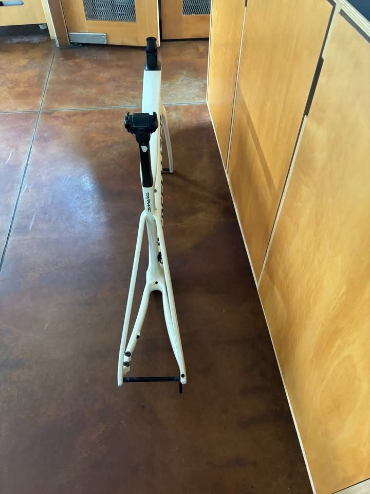 Off-white Specialized Tarmac SL7 frame laid on a dark table with its fork and carbon seatpost alongside, from the seller's Marketplace listing. Photo 7 of 7.